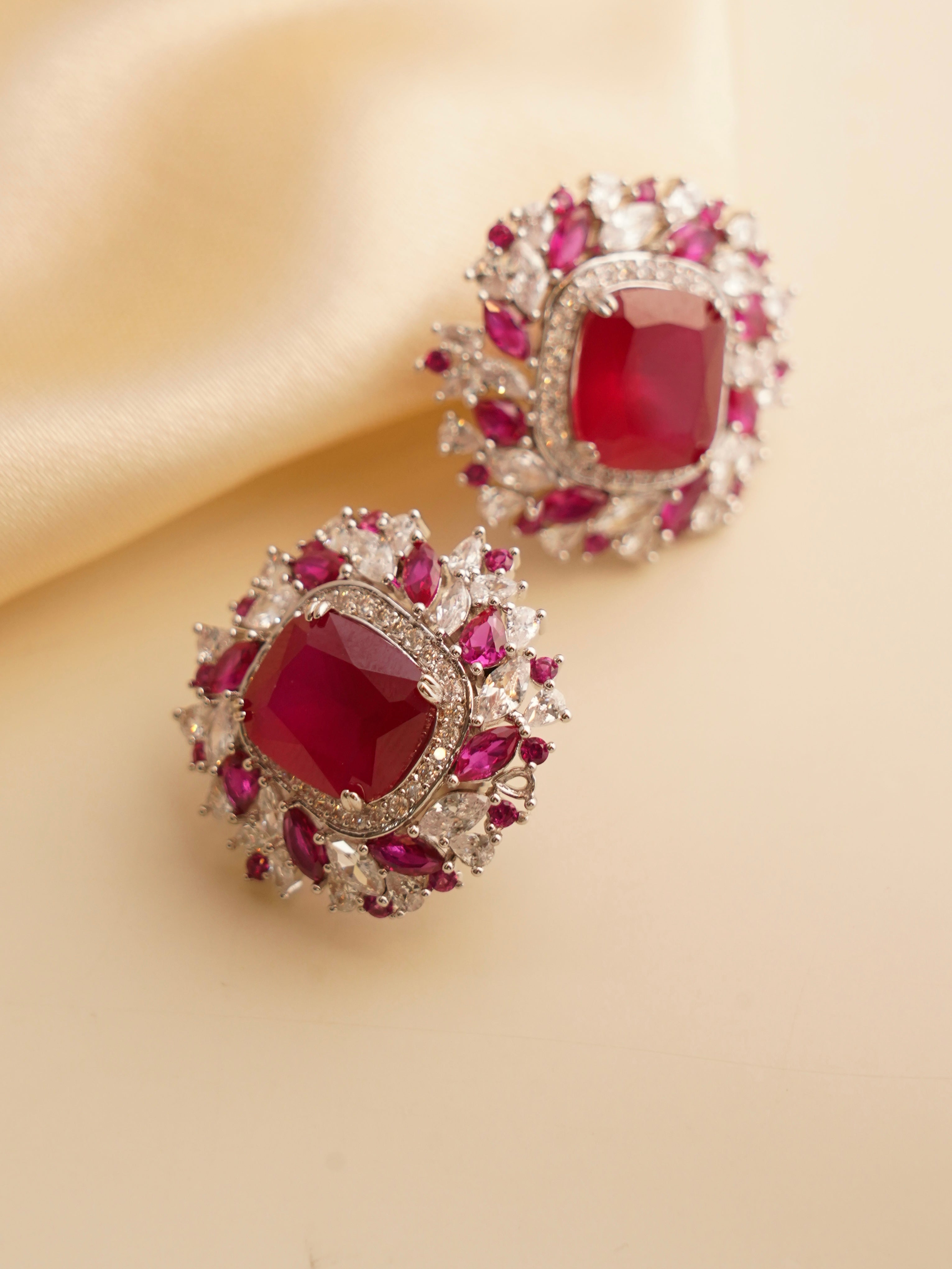 Round Swarovski stud earrings in emerald green with halo of brilliant-cut crystals and screw-back closure